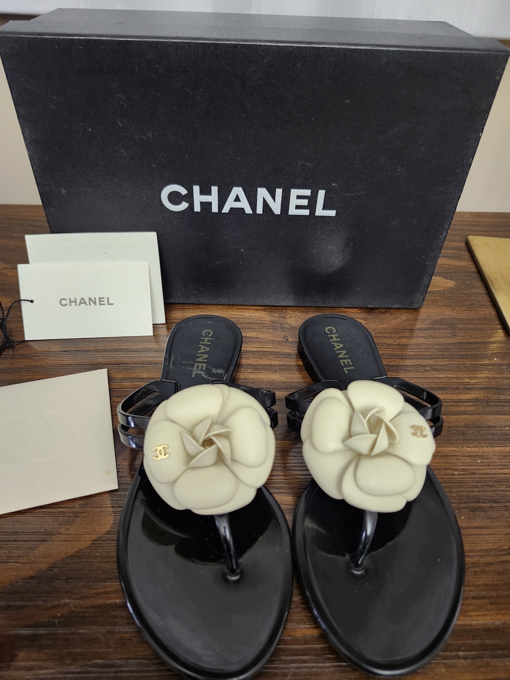Chanel Women's Black Jelly Thong Sandals with Cream CC Camellia - Size 36